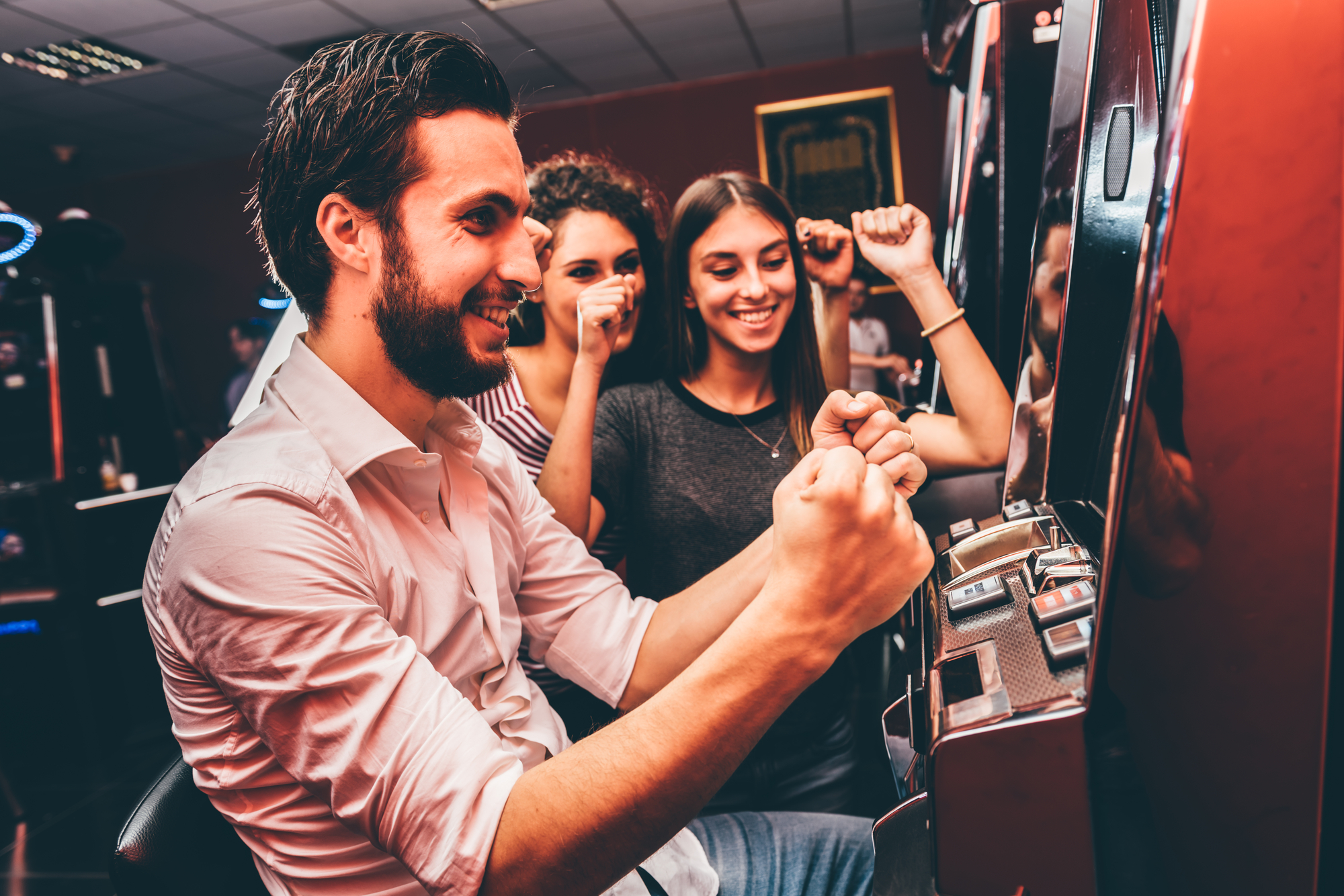 Group Of Friends Playing Slot Machines